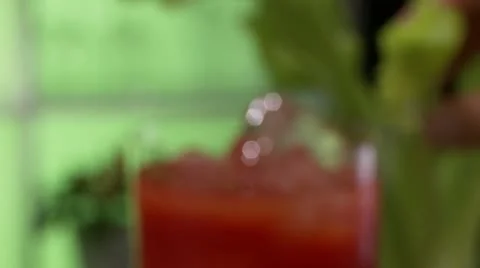 Tomato juice garnished with a stick of celery Stock-Footage 24638690