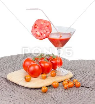 Tomato juice in the glass, orange cherry tomatoes and red tomatoes on vine is Stock Photos