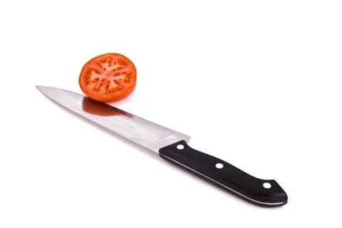 Tomato with knife Stock Photos