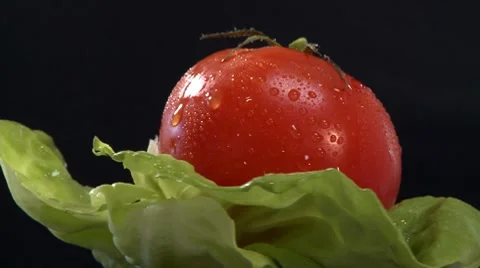 A tomato on a lettuce leaf Stock Footage 8573992