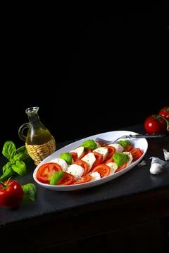 Tomato with mozzarella and basil Stock Photos