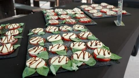 Tomato, Mozzarella, Basil Leaves and Balsamic on a Slate Serving Plate Stock Footage 321647558