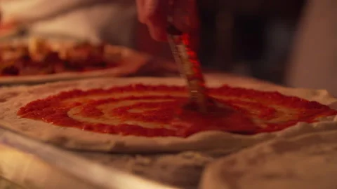 Tomato paste going on a pizza base Stock Footage 282643418