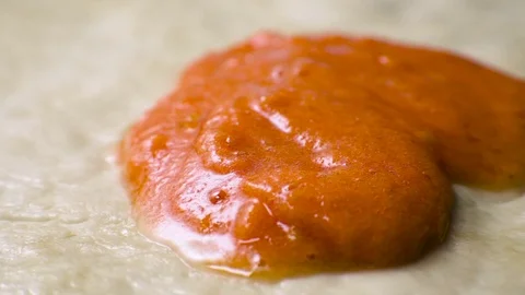 Tomato paste on a thin dough for pizza. Video Stock Footage 85101635