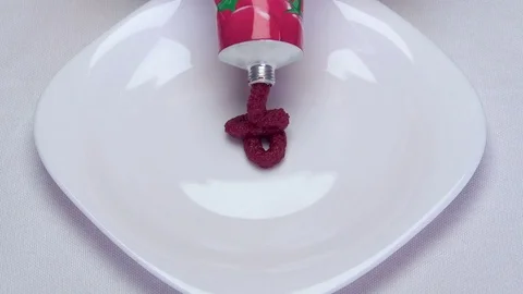 Tomato paste on white plate Stock Footage 73344902