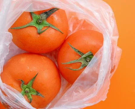 Tomato in plastic bag Stock Photos