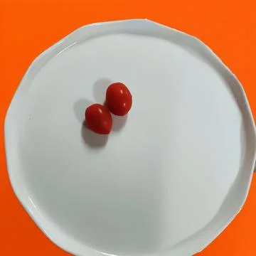 Tomato on plate Stock Photos