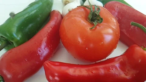 Tomato red pepper, garlic on white background black pepper drops Stock Footage 88220605