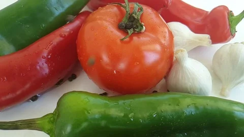 Tomato red pepper, garlic on white background black pepper drops Stock Footage 88220611