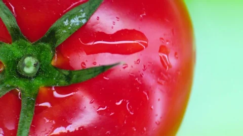 Tomato rotates on a green background. top view. Closeup. Stock Footage 129721218