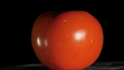 Tomato rotating on a base with a black background. Stock Footage 113899099