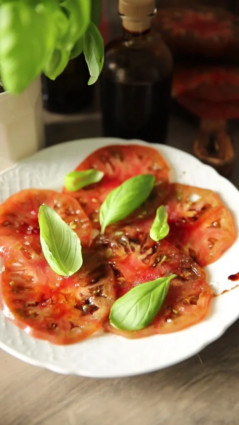 Tomato salad sliced vegetables, olive oil carpaccio food preparation tasty Stock Footage 339697444