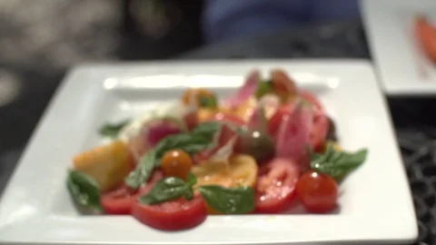 Tomato salad in table in slow motion Stock Footage 112032242