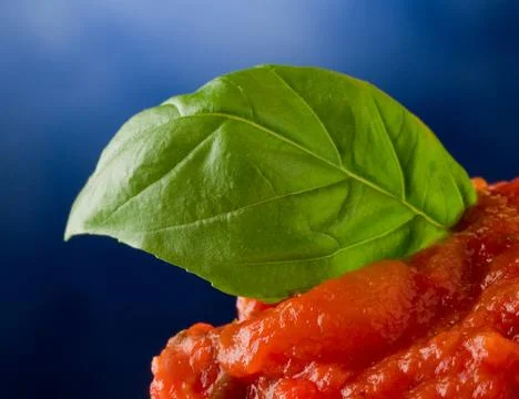 Tomato sauce with basil leaf background Stock Photos
