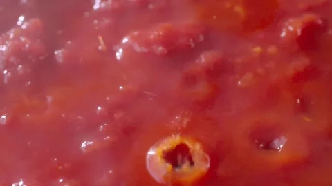 Tomato sauce boiling. Pan Left. Close up. Slow motion. Boiling tomato sauce made 動画素材 148198760