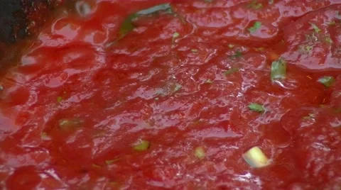 Tomato sauce cooking on an open fire. Close up. Video stock 51883366