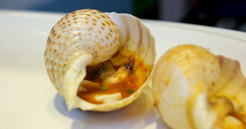 Tomato sauce in shells Add chili pepper to hot shellfish cooking Stock Footage 276576368