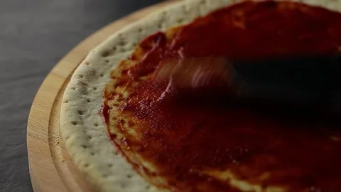Tomato sauce is spread with a spatula 動画素材 218382933