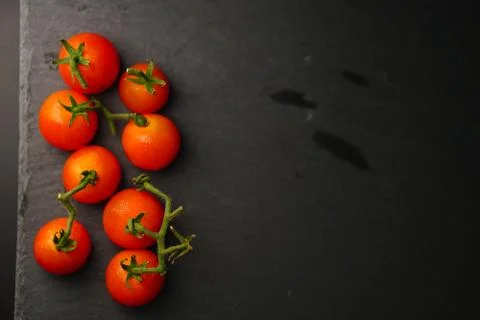 Tomato on slate plate over dark background. Selective Focus, Healthy Lifestyl Stock Photos