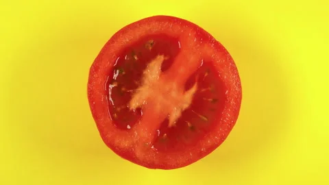 Tomato slice rotating top view on yellow background.Macro food.bio food. Stock Footage 152178403