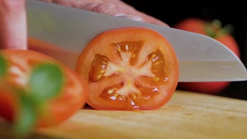 Tomato sliced close-up in slow motion Stock Footage 156258973