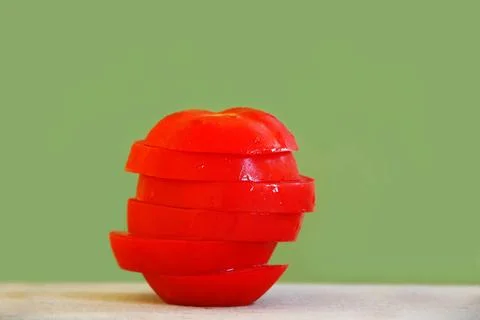 Tomato slices stack red ripe appetizing tomato slices in stack over light ... 스톡 사진