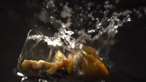 Tomato slow motion closeup falling in water with Splash video Stock Footage 124734865