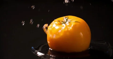Tomato slow motion closeup falling in water macro Stock Footage 125354749