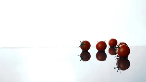 Tomato in slow motion on wet surface Stockbeeldmateriaal 95273673