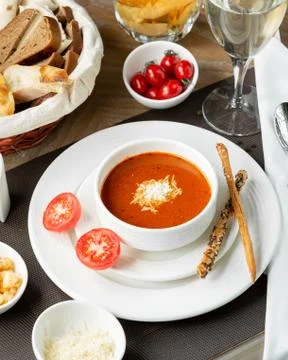 Tomato soup with cheese chips Stock Photos