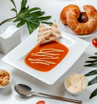 Tomato soup with cheese on the table Stock Photos