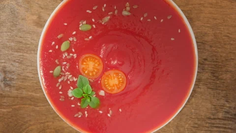 Tomato soup gazpacho on table rotate top view Stock Footage 280264700