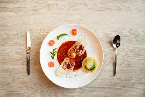 Tomato soup on kitchen table in cafe Stock Photos