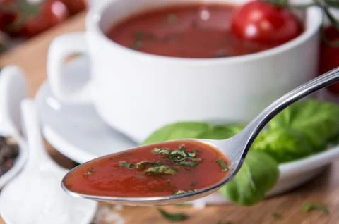 Tomato soup with spoon Stock Photos