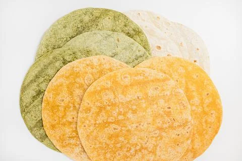 Tomato, spinach flavored and plain wheat tortilla wraps on white background Stock Photos