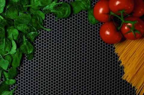 Tomato spinach spaghetti on a dark background semicircular top place to insert Stock Photos