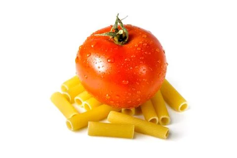 Tomato standing on macaroni Stock Photos