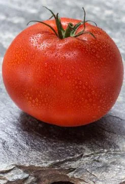 Tomato on stone background macro Stock Photos