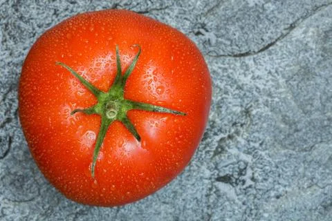 Tomato on stone background macro 스톡 사진