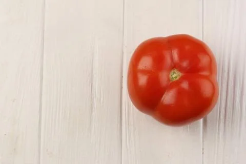 Tomato on the table. Close up. White background Stock Photos