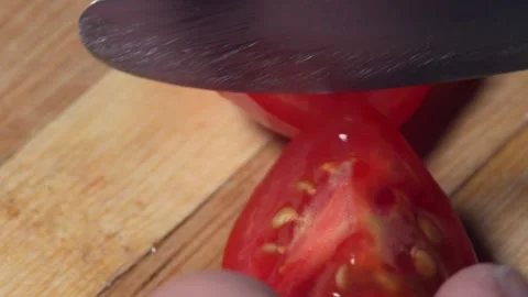 Tomato is tangible with Macro lens and divided into two and divided into pieces Stock Footage 317823028