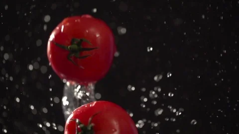 Tomato throw up with water splash droplets slow motion macro Stock Footage 124735547