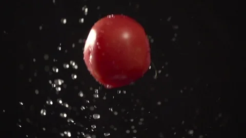 Tomato throw up with water splash droplets slow motion closeup macro Stock Footage 125337908