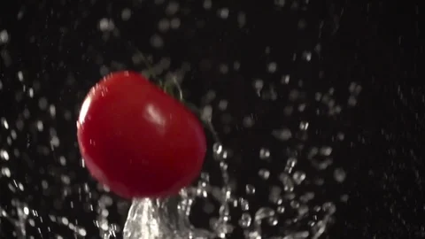 Tomato throw up with water splash droplets slow motion closeup macro Stock Footage 125337941