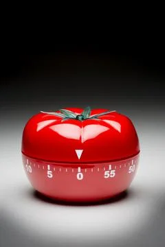 Tomato timer to fight procrastination. Stock Photos