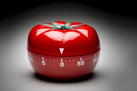 Tomato timer to fight procrastination. Stock Photos