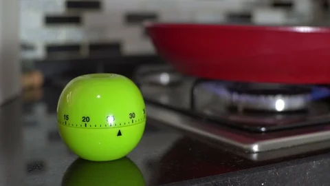 Tomato timer pomodoro / Cooking in kitchen - Red Pan , selective focus Stock Footage 129438743