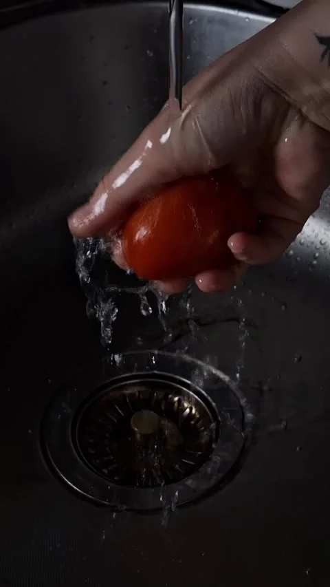 Tomato under a tap with water Stock-Footage 342662671