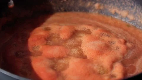Tomato vegetable sauce boiling in saucepan in the process of cooking. Selective Stock Footage 201142674