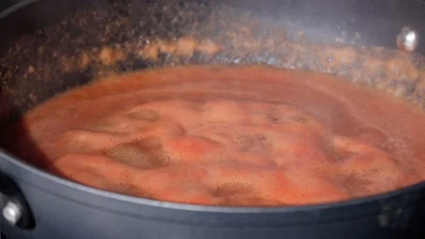 Tomato vegetable sauce boiling in saucepan in the process of cooking. Selective Stock Footage 201480259